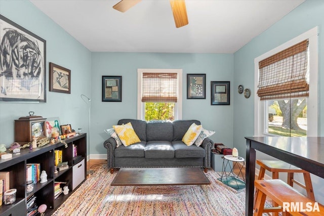 living room featuring wood-type flooring, a wealth of natural light, and ceiling fan