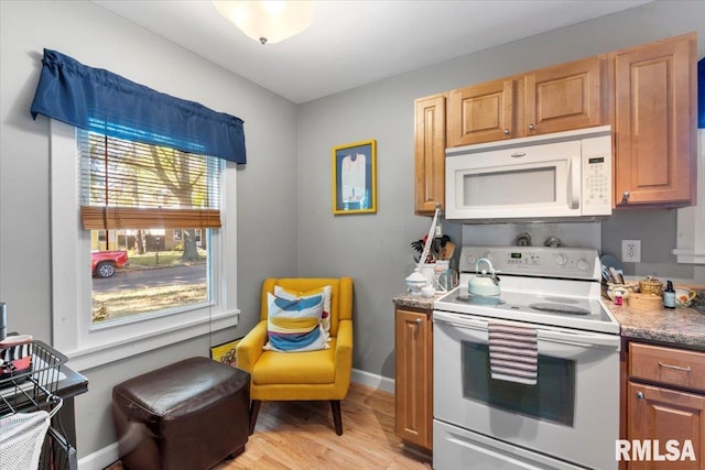 kitchen featuring white appliances and light hardwood / wood-style flooring