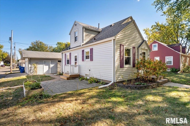 view of front of home with a patio area, a front yard, and a storage unit