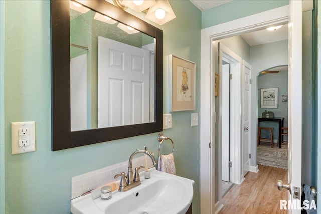 bathroom with wood-type flooring and sink