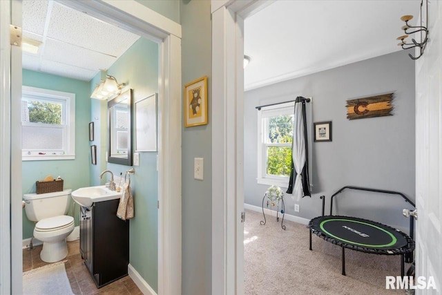 bathroom featuring vanity, plenty of natural light, and toilet