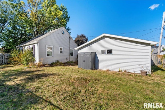 view of side of property with a shed and a lawn