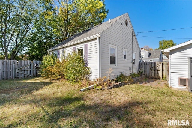 view of side of home featuring a yard