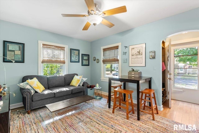 living room featuring ceiling fan and light hardwood / wood-style flooring