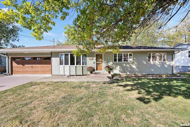 ranch-style house with a garage and a front lawn