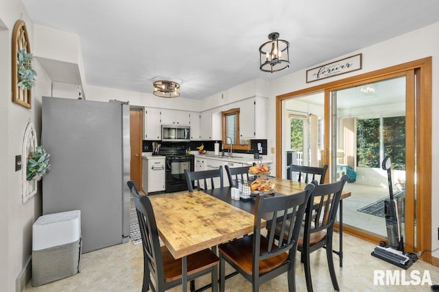 dining room with a chandelier and sink