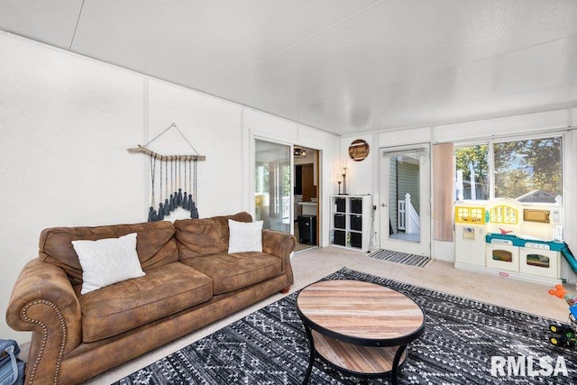 living room featuring carpet and a wealth of natural light