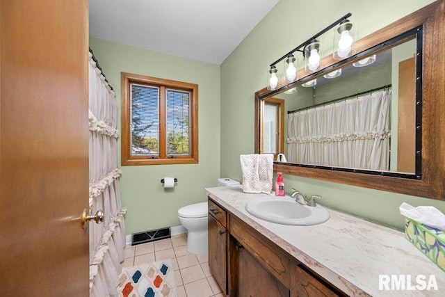 bathroom with vanity, toilet, and tile patterned floors