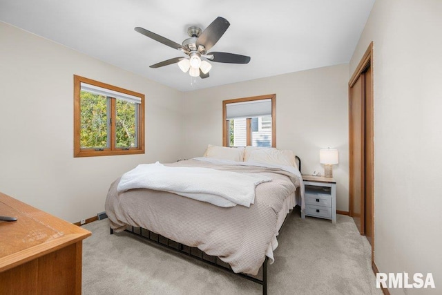 carpeted bedroom with a closet and ceiling fan