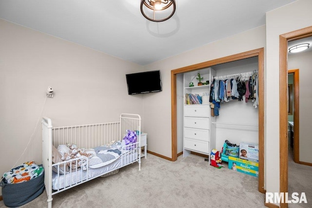 carpeted bedroom featuring a crib