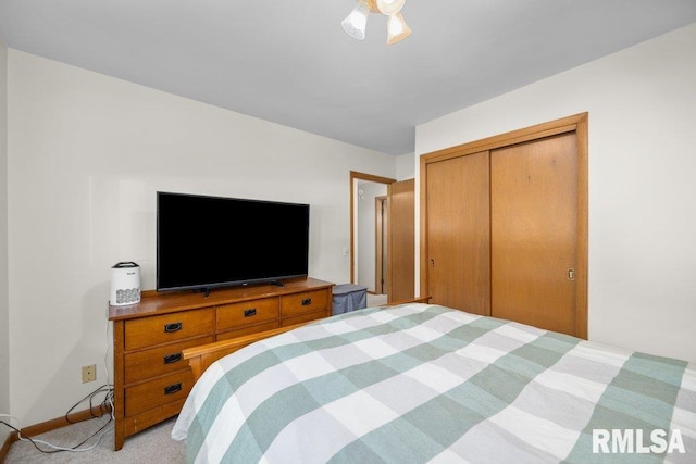 bedroom featuring a closet and light colored carpet