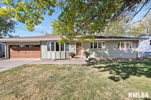 single story home featuring a garage and a front lawn