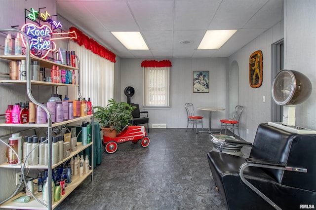 interior space with a paneled ceiling