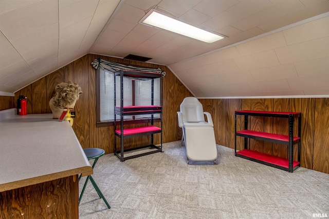 bonus room with vaulted ceiling, light carpet, and wood walls