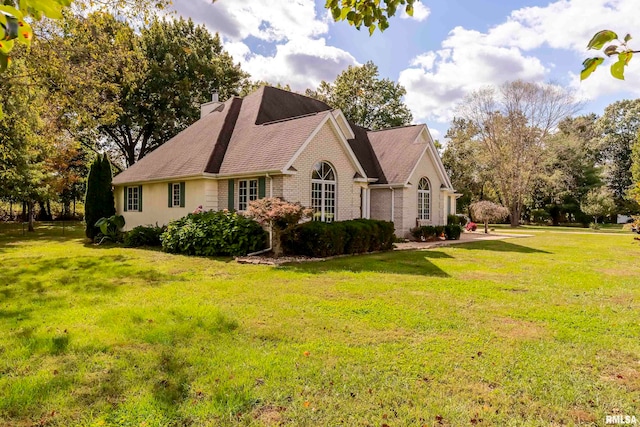 view of side of home with a lawn