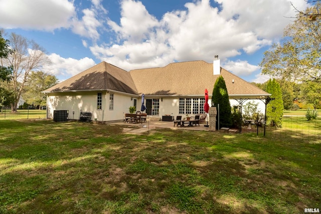 back of property with a patio area, central AC, and a yard