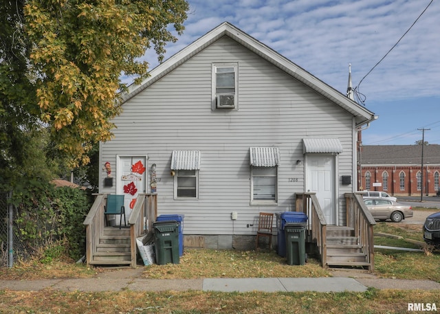 rear view of property with cooling unit