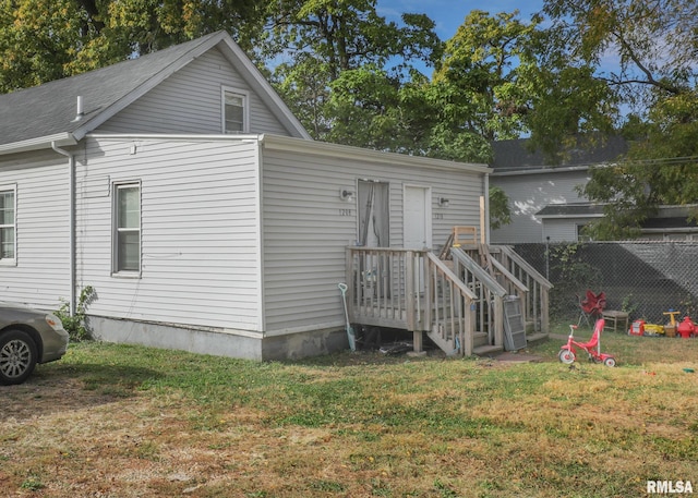 rear view of property featuring a yard