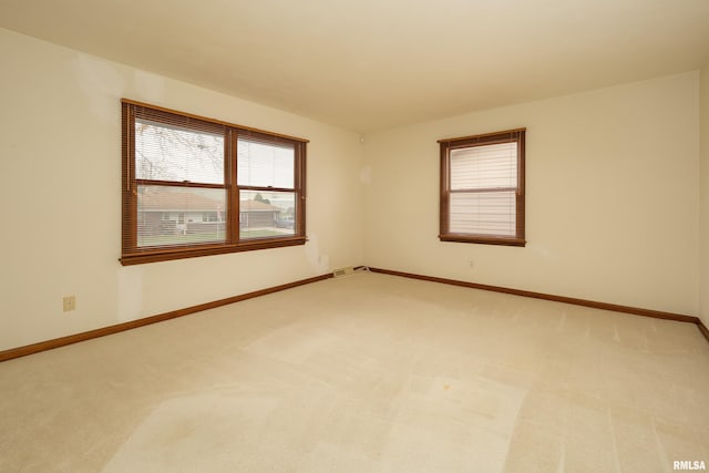 empty room featuring light carpet