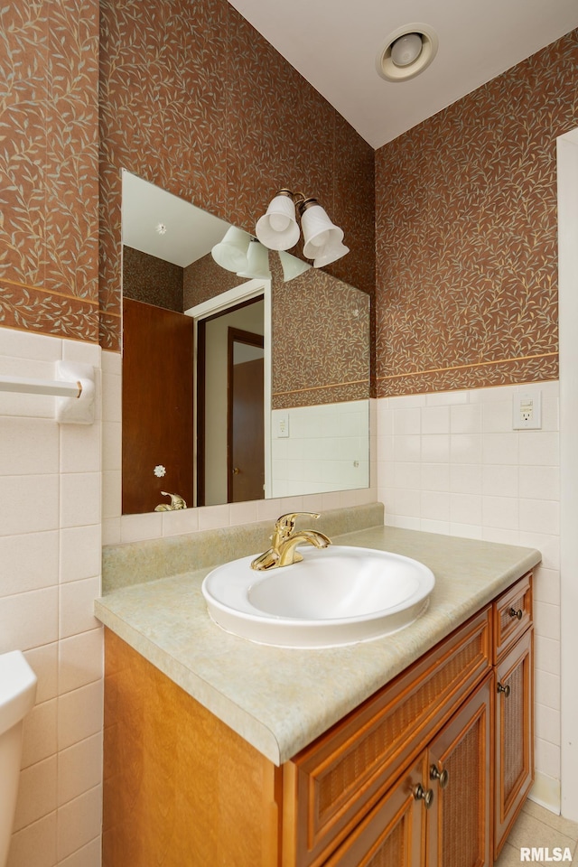 bathroom featuring vanity and tile walls