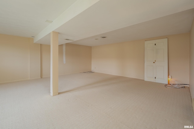 basement featuring light colored carpet