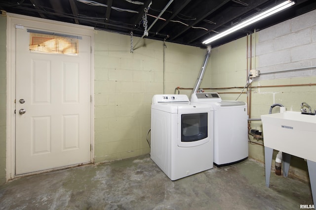 clothes washing area with separate washer and dryer