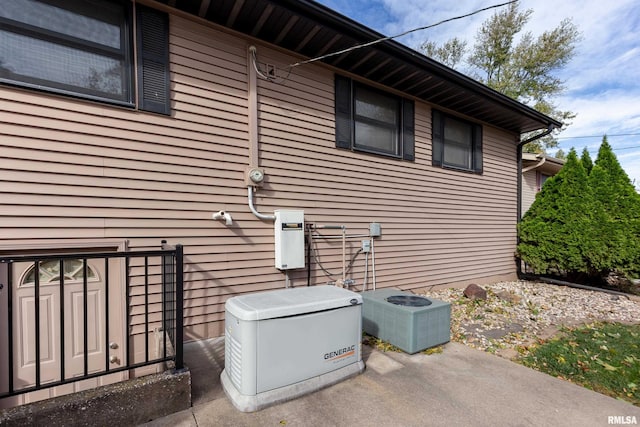 view of side of home with central AC