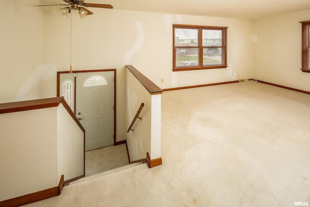 entrance foyer with light carpet and ceiling fan