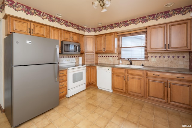 kitchen featuring decorative backsplash, sink, and appliances with stainless steel finishes