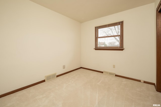 spare room with light colored carpet