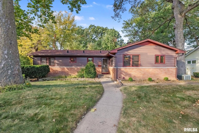 ranch-style home with central air condition unit and a front lawn