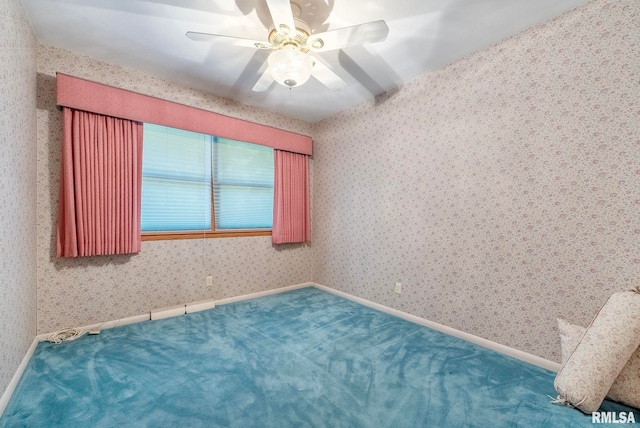 carpeted empty room featuring ceiling fan