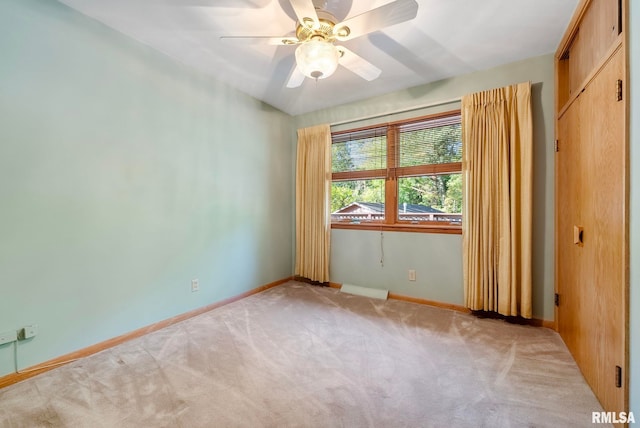 unfurnished room featuring light carpet and ceiling fan