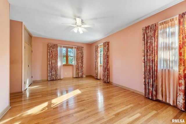 unfurnished room featuring light wood-type flooring and ceiling fan