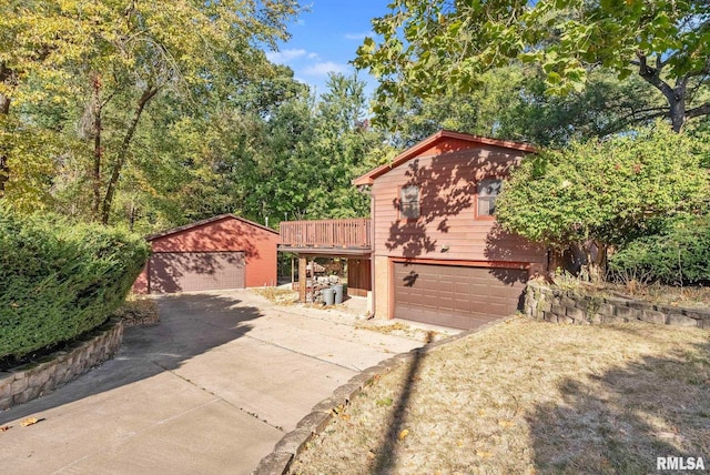 view of front of house featuring a deck, an outbuilding, and a garage