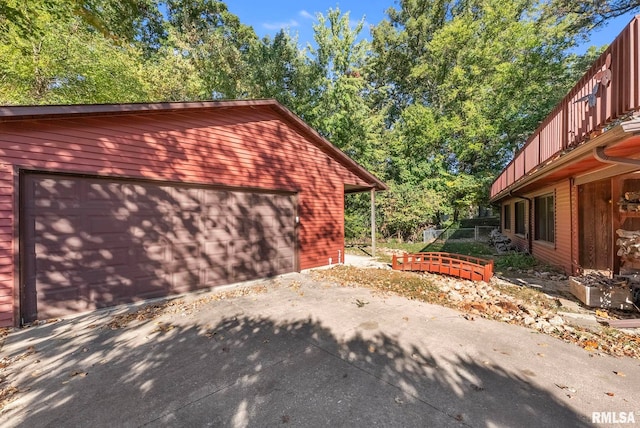 view of side of property featuring a garage and an outbuilding