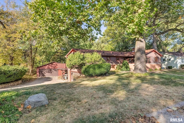 view of front of house with a garage, a front lawn, and an outdoor structure