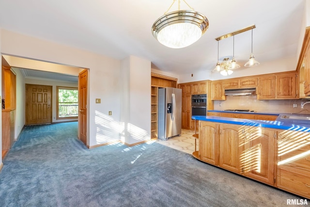 kitchen featuring decorative backsplash, hanging light fixtures, stainless steel appliances, sink, and light colored carpet