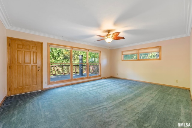 carpeted spare room featuring crown molding and ceiling fan