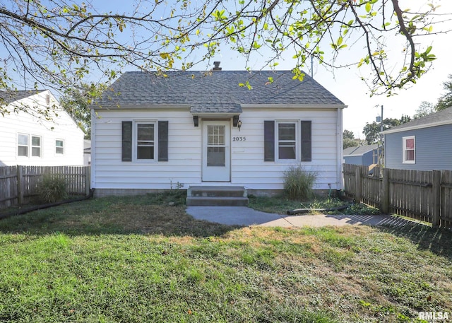 bungalow-style house with a front lawn