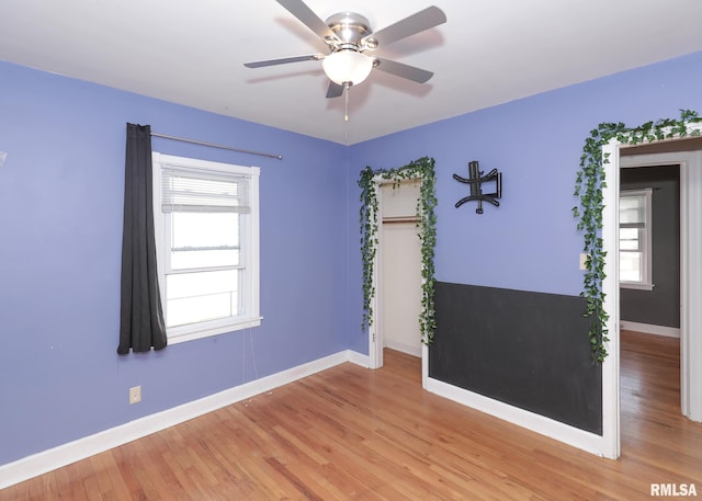 spare room with light hardwood / wood-style floors and ceiling fan