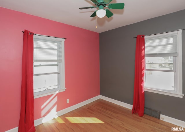 spare room featuring light wood-type flooring and ceiling fan