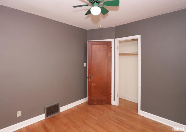 unfurnished bedroom with a closet, ceiling fan, and light hardwood / wood-style flooring