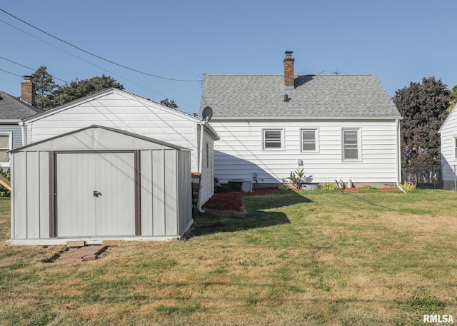 rear view of property featuring a yard, a shed, and central AC unit