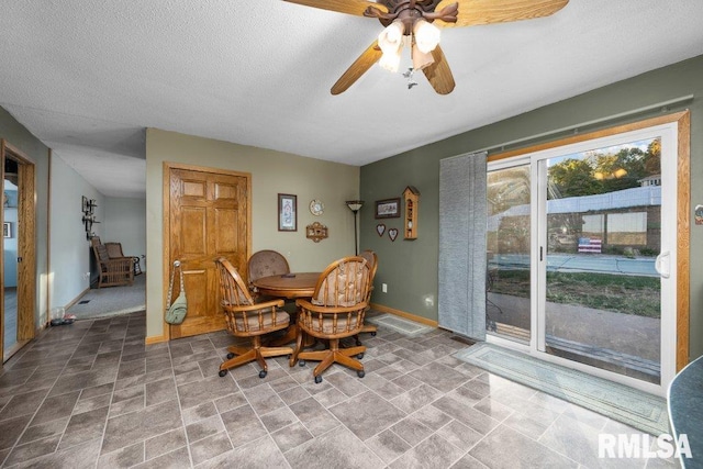 dining room featuring ceiling fan and a textured ceiling