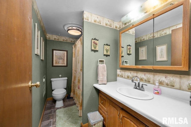 bathroom with vanity, toilet, and backsplash