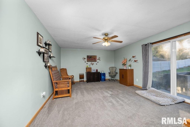 sitting room featuring a textured ceiling, light colored carpet, and ceiling fan