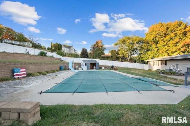 view of pool featuring a patio and a water slide