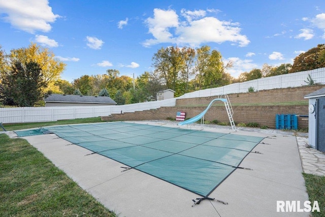 view of swimming pool with a water slide