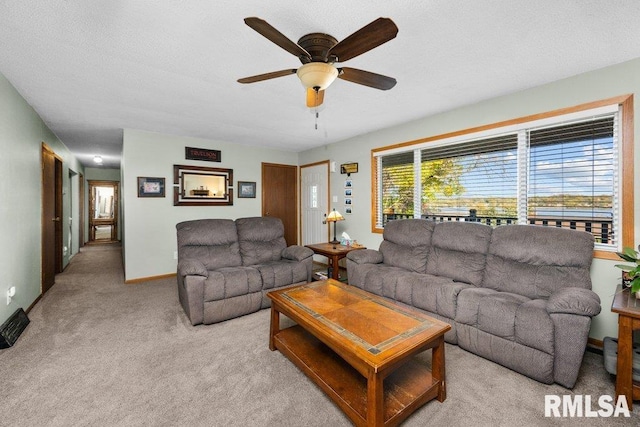 carpeted living room with ceiling fan